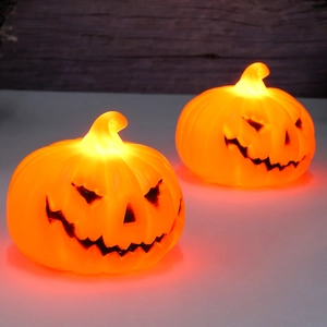 Set of two glowing orange Halloween pumpkin LED lanterns with classic Jack-O-Lantern faces
