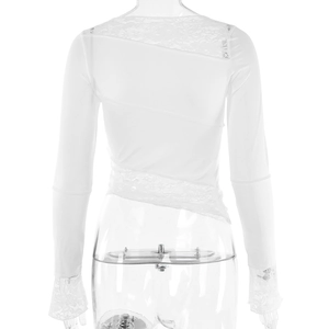 Detailed back view of white long-sleeve top featuring intricate lace patchwork details