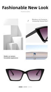Close-up of cat-eye sunglasses featuring black frames and purple gradient resin lenses
