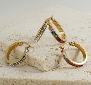Macro side view of 18K gold-plated earrings with white and rainbow cubic zirconia