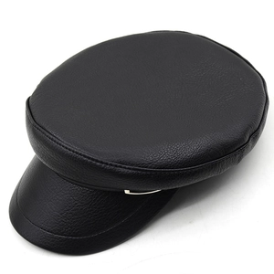 Detail of black PU leather baker boy hat with metal buckle and textured visor