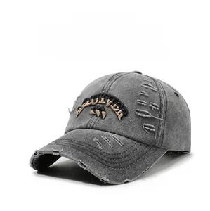 Detail of distressed grey denim baseball cap featuring embroidery and vintage ripped brim