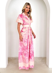 Detail of printed dress featuring puff sleeves, lapel collar, and matching fabric belt