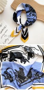 Detail of silk-texture square scarf featuring equestrian horse carriage print and yellow borders