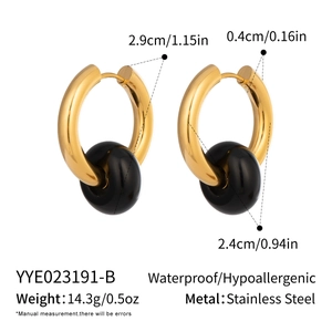 Detailed view of 18K gold plated stainless steel hoops with black natural stone beads
