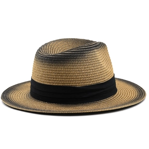 Detail of two-tone gradient straw fedora hat featuring a black band and woven texture