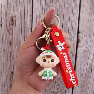 Detail of Christmas elf PVC doll keychain with red silicone wristband and gold metal ring