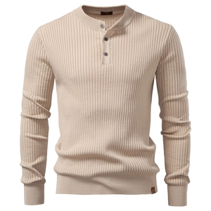 Detail of beige ribbed knit Henley shirt featuring three-button placket and fabric texture