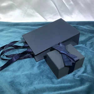 Dark blue jewelry gift set including textured box with ribbon bow and matching paper bag