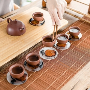 Japanese resin wood coaster with Kung Fu tea set on bamboo mat from a top view