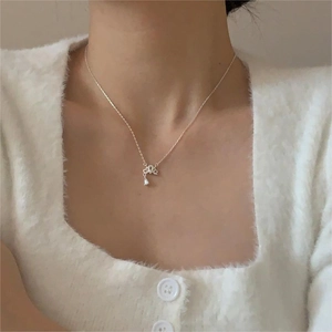 Close-up of 925 sterling silver crown necklace with drop-shaped zircon pendant