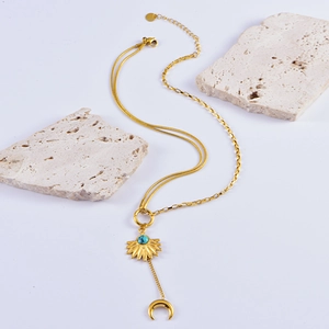 Gold layered sun and moon necklace with turquoise stone and celestial tassel pendant