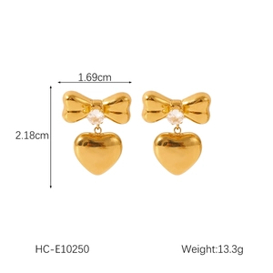 Detail view of 18K gold bow heart earrings with zircon inlay and product dimensions