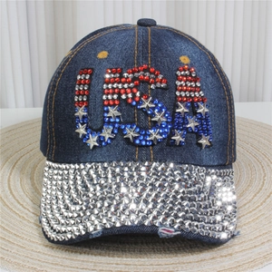 Close-up of USA rhinestone letters and silver metal studs on dark blue denim baseball cap