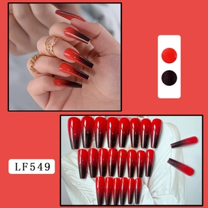 Detail of long coffin nails featuring black and red gradient design with subtle glitter finish