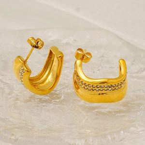 Golden C-shaped stainless steel earrings with double row rhinestones on a glass tray