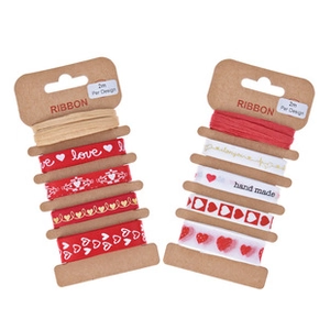 Detail of love and handmade heart pattern ribbons on brown paper spools, 2m length each