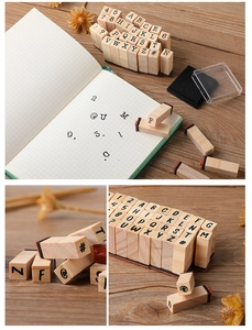 Detail view of typewriter style wooden stamps featuring letters and numbers for DIY journals