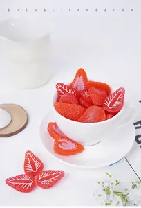 Macro view of artificial strawberry slices in a white cup for creative food photography