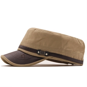 Close-up of khaki canvas cadet cap with brown leather brim and metal star detail