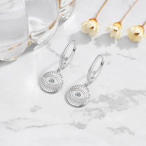S925 sterling silver evil eye hoop earrings with bright zircon stone on marble surface