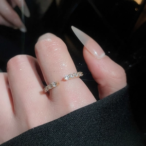 Close-up of gold adjustable ring featuring micro-set cubic zirconia on hand