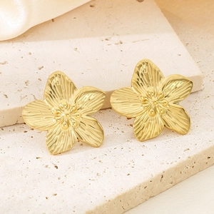 Macro shot of 18K gold plated stainless steel floral earrings with textured petals