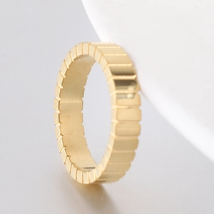 Detailed macro view of 4mm golden stainless steel ring with quilted pattern design