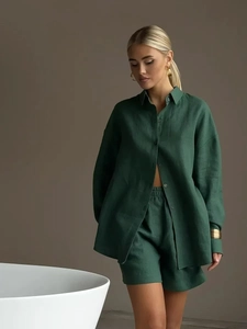 Detailed macro view of the forest green linen texture on shirt and high-waist shorts set
