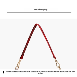 Detail view of red plaid shoulder strap with golden lobster clasps for handbags