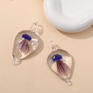 Detail view of teardrop glass pendants featuring blue and purple jellyfish ornaments