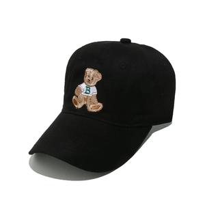 Detailed close-up of a teddy bear embroidery on a black cotton twill baseball cap