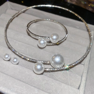 Detail of silver jewelry set featuring sparkling diamonds and pearls in a luxury velvet box