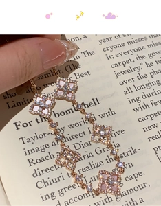 Detail of rose gold clover bracelet with pink shell inlay and pavé zircon stones