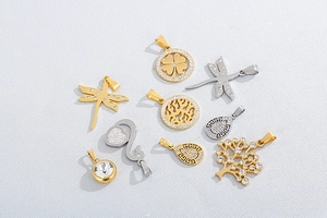 Macro shot of assorted rhinestone tree and dragonfly pendants in gold and silver finish