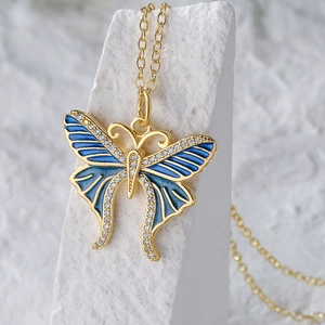 Butterfly pendant necklace in 18K gold plated copper with blue enamel and zircon stones