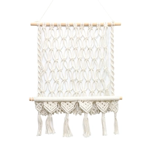 Macramé mural fait main avec motifs de cœurs et franges sur poutres en bois