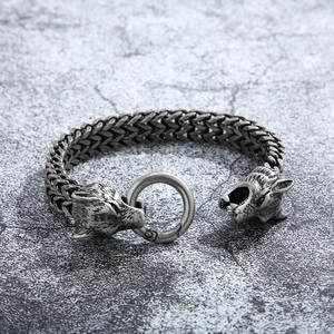 Detailed view of vintage silver double wolf head titanium steel bracelet with woven chain