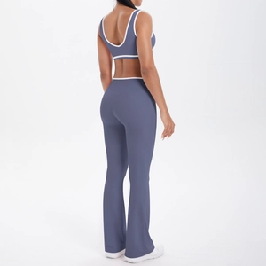 Detail of cross-waist yoga set in misty blue with white piping and flared legs