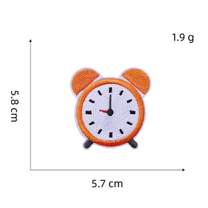 Cartoon alarm clock embroidered patch measuring 5.8 cm x 5.7 cm on white background