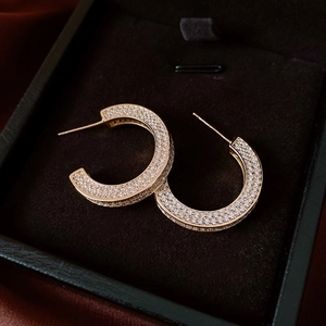 Macro shot of 14k gold-plated hoop earrings with pave-set sparkling cubic zirconia