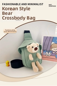 Detail of light green canvas kids bag with cute plush bear and adjustable black strap