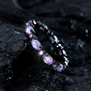 Gothic black gold eternity ring with oval opal stones and sparkling zircon accents