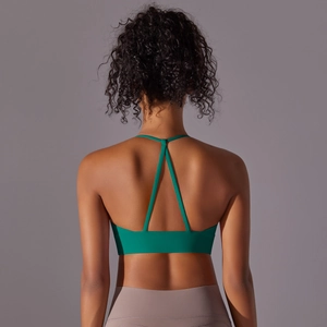 Detail of emerald green sports bra featuring a Y-shaped cross back and thin straps