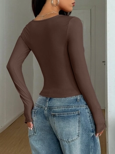 Rear view of a tight brown long-sleeved Y2K top showcasing the slim fit on a female model
