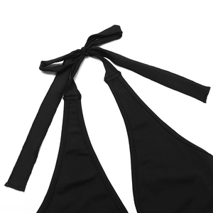 Close-up of black halter neckline with adjustable tie details on a slim lace jumpsuit
