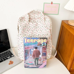 Detail showing student backpack capacity fitting a B5 size magazine inside a floral bag