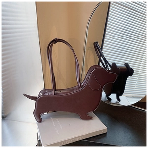 Detailed view of a creative dachshund-shaped shoulder bag in dark brown leather