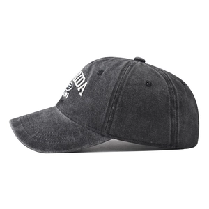 Macro detail of the white Florida Miami embroidery on a dark grey washed cotton cap
