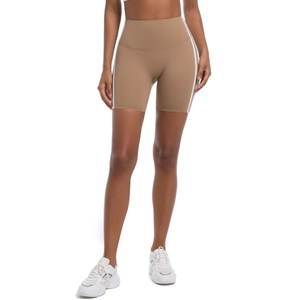 Detail of high waist brown yoga shorts featuring side white stripes and breathable fabric